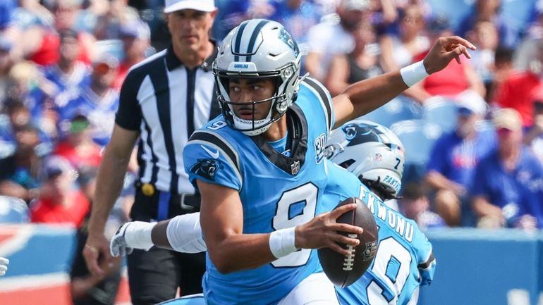 Carolina Panthers quarterback Bryce Young scrambles in the first half...