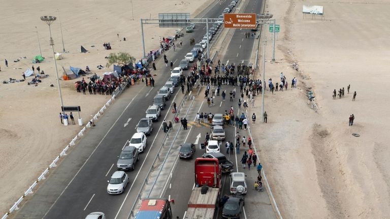 Stranded Venezuelan migrants block the border crossing in Tacna, Peru,...