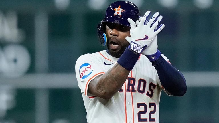 Houston Astros' Jason Heyward celebrates after hitting a two-run double...