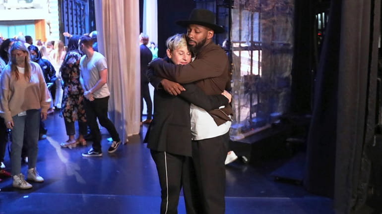 Ellen DeGeneres embraces colleague Stephen "tWitch" Boss on the set...