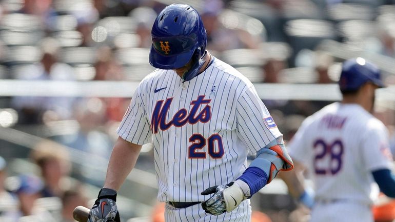 Pete Alonso of the Mets walks back to the dugout...