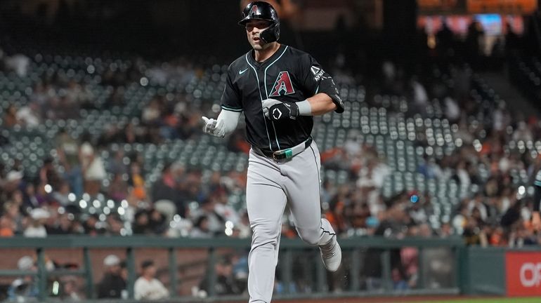 Arizona Diamondbacks' Randal Grichuk reacts after hitting a home run...