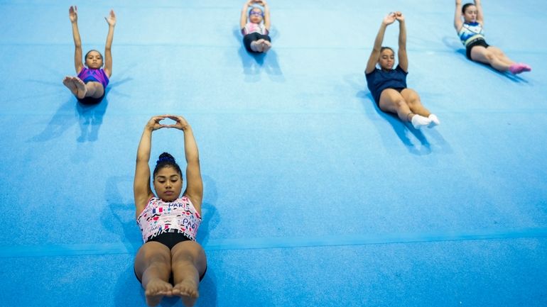 Panamanian gymnast Hillary Heron stretches as she trains for the...