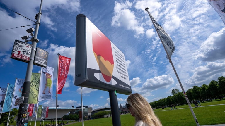 A woman passes a billboard for the European Election on...