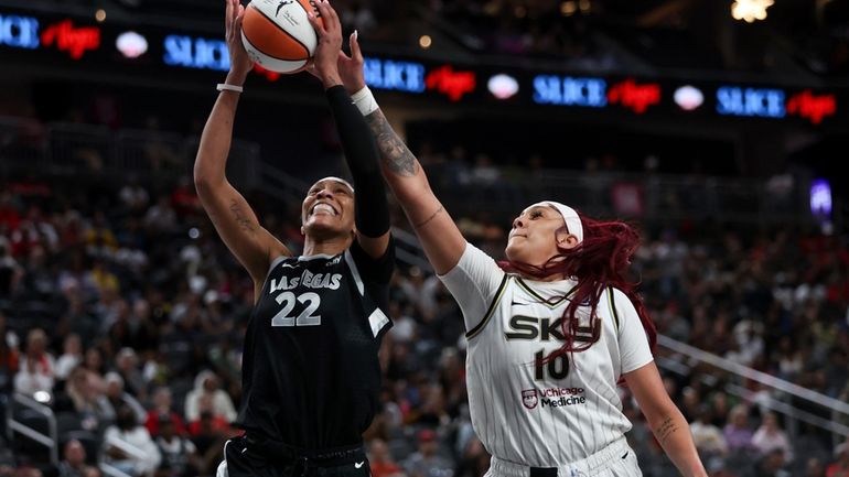 Las Vegas Aces center A'ja Wilson (22) shoots and is...