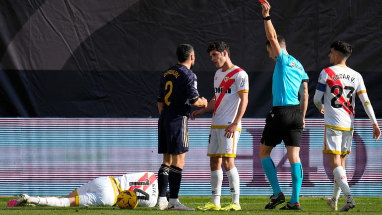 Referee Alejandro Muniz Ruiz shows a red card to Real...