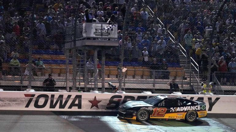 Ryan Blaney crosses the finish line as he wins a...