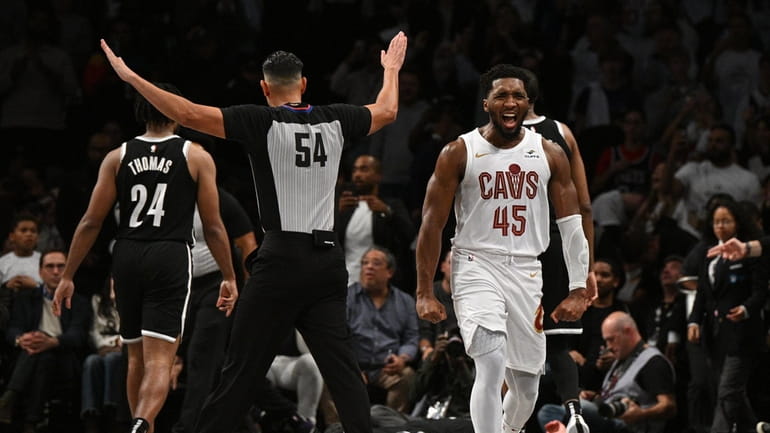 Cleveland Cavaliers guard Donovan Mitchell reacts after Nets guard Cam...