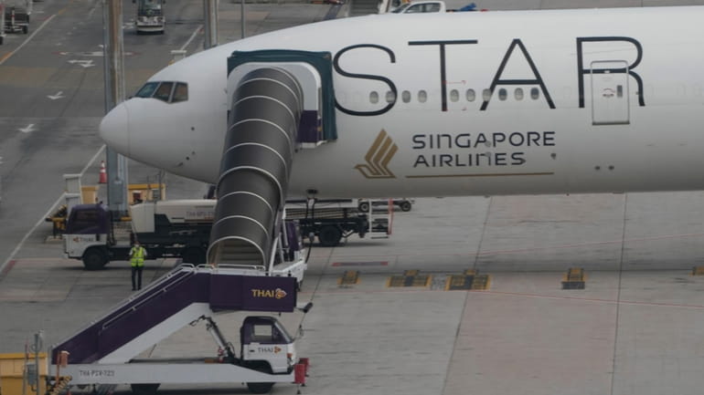 The Singapore Airlines Boeing 777-300ER aircraft is parked after the...