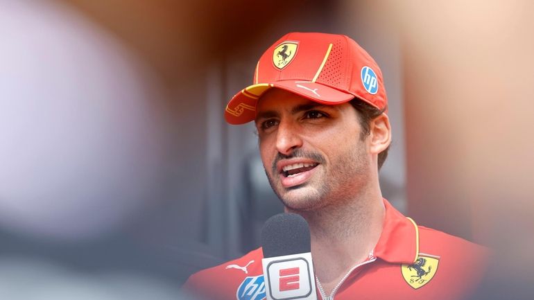 Ferrari driver Carlos Sainz of Spain speaks with the media...