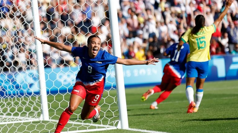 Mallory Swanson of the United States celebrates after scoring the...