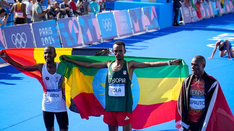 Belgium's Bashir Abdi, left, Ethiopia's Tamirat Tola, center, and Kenya's...