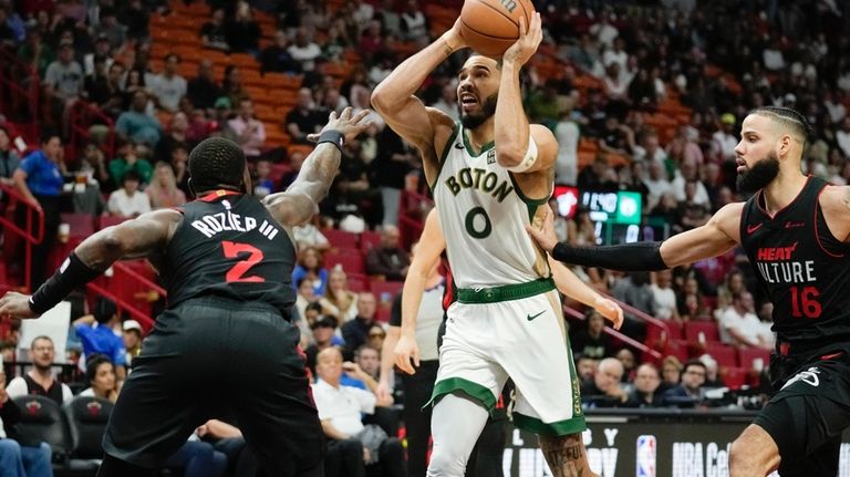 Boston Celtics forward Jayson Tatum (0) looks for an opening...