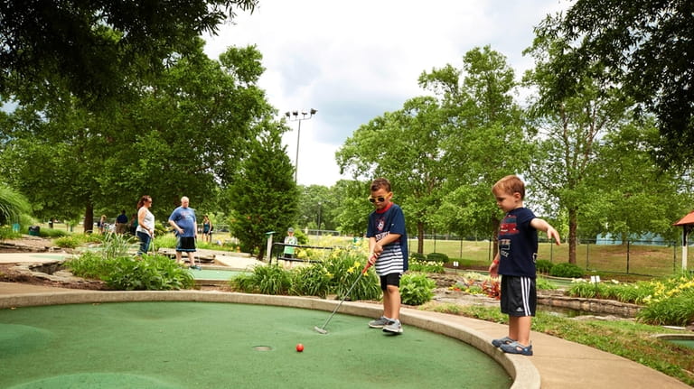 Maxton and Brody Shafran play mini golf at Eisenhower Park...