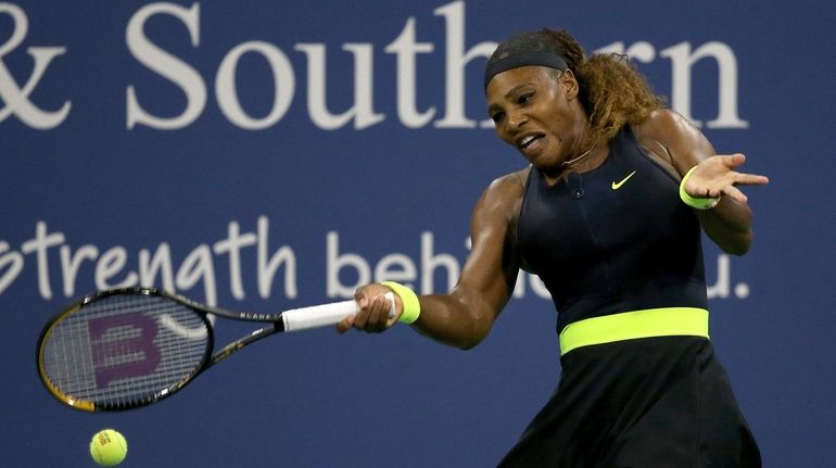 Serena Williams returns a shot to Maria Sakkari during the...