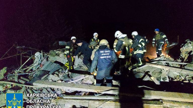 In this photo provided by Kharkiv Regional Prosecutor's Office, firefighters...