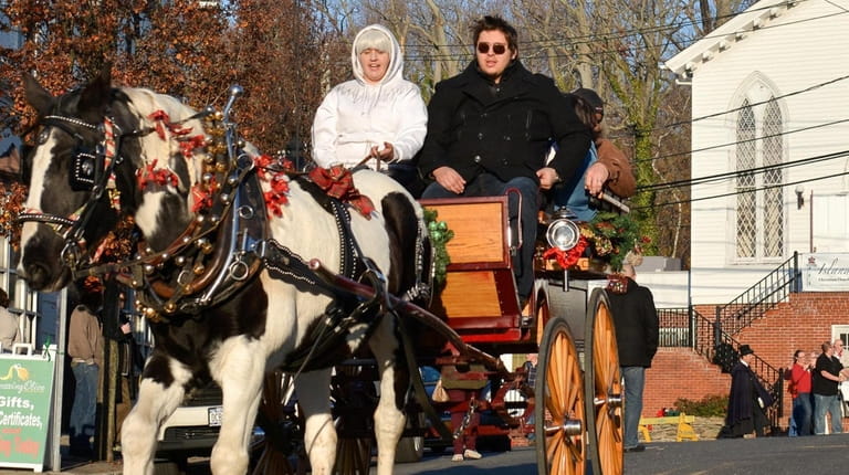 Visitors to the annual Charles Dickens Festival take a horse-drawn...