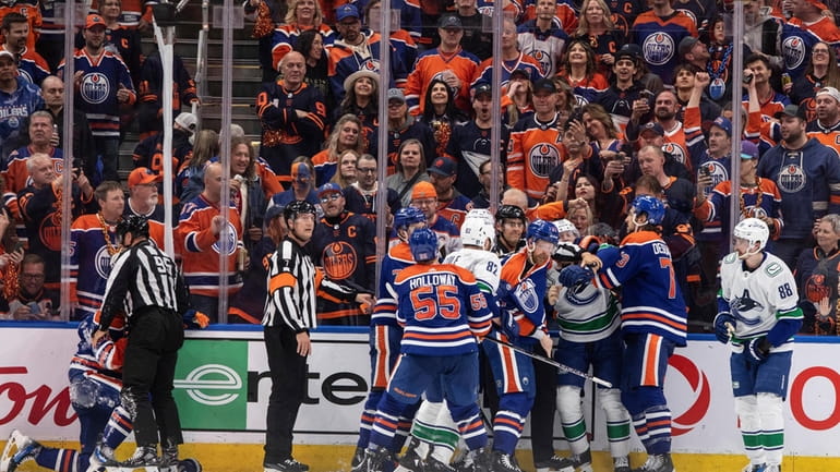 Vancouver Canucks and Edmonton Oilers rough it up during the...