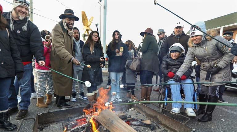 Visitors to Port Jefferson's annual Charles Dickens Festival roast marshmallows...