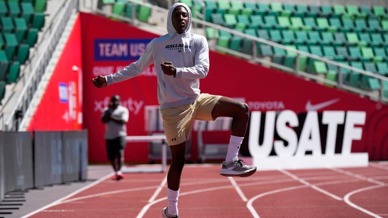 Eric Gregory stretches on the track at the U.S. Olympic...