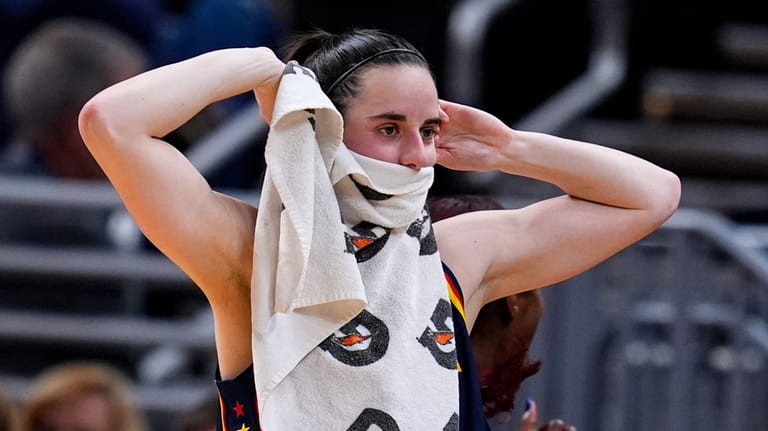 Indiana Fever guard Caitlin Clark reacts after a teammate's basket...