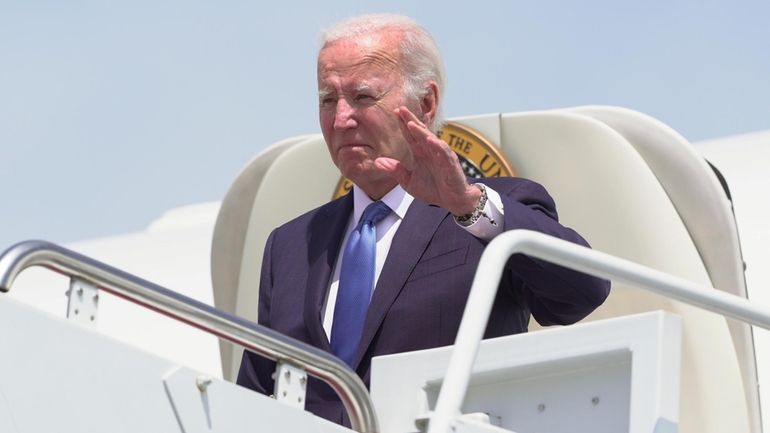 President Joe Biden disembarks Air Force One as he arrives...