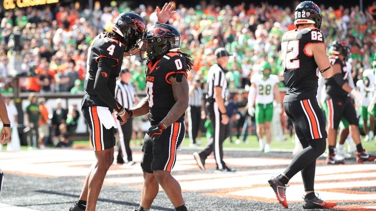 Oregon State running back Anthony Hankerson (0) celebrates after scoring...