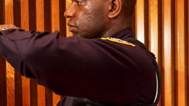 New York City Police Officer Jorbin Charles models a bulletproof...