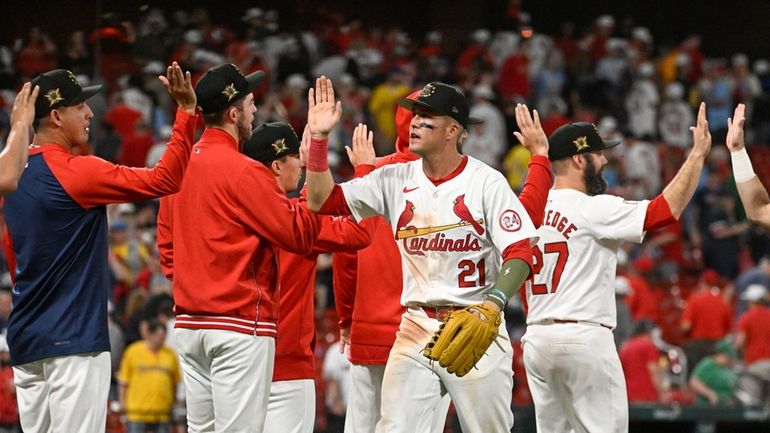 St. Louis Cardinals right fielder Lars Nootbaar (21), center, and...