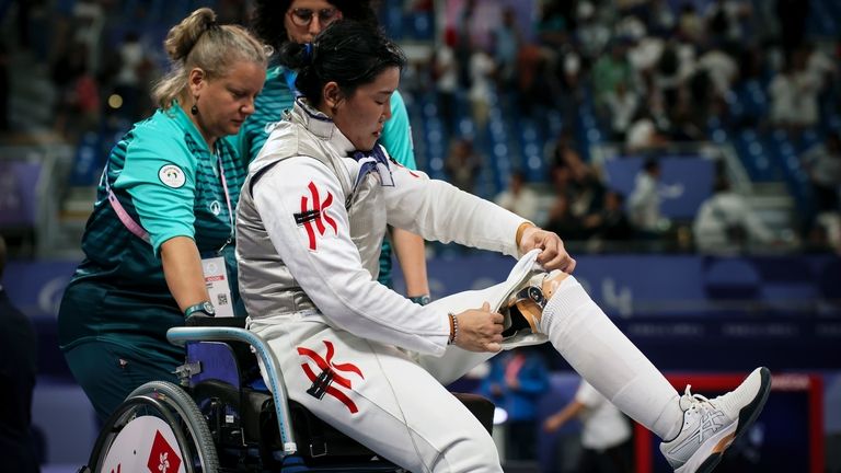 China's Chui Yee Yu replaces her prosthesis after her victory...