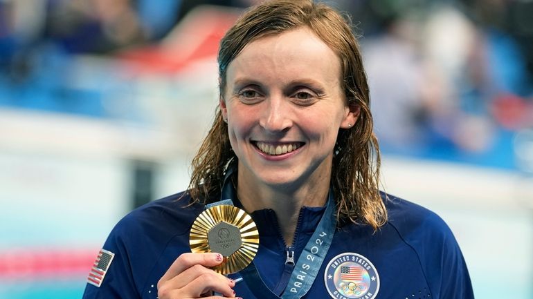 United States' Katie Ledecky celebrates with the gold medal during...