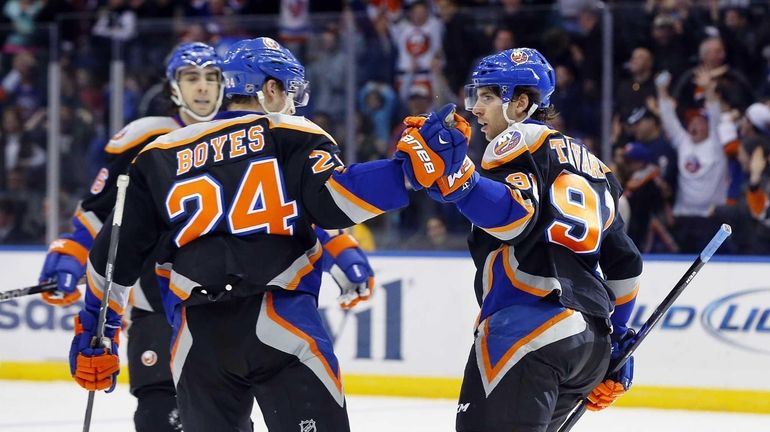 John Tavares celebrates his third-period goal with Brad Boyes during...