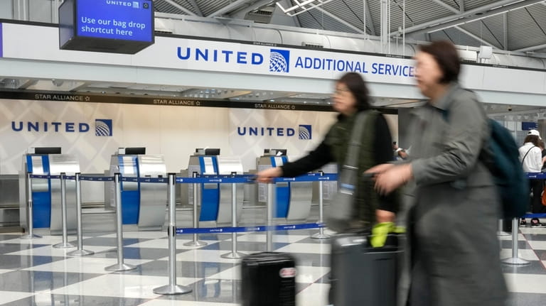 United Airlines passengers head to a security checkpoint at O'Hare...