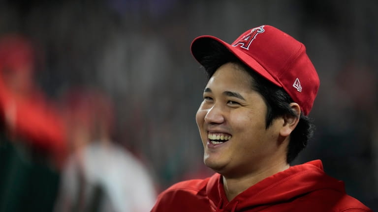 Los Angeles Angels' Shohei Ohtani laughs in the dugout during...
