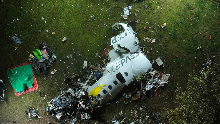 The debris at the site where an airplane crashed with...