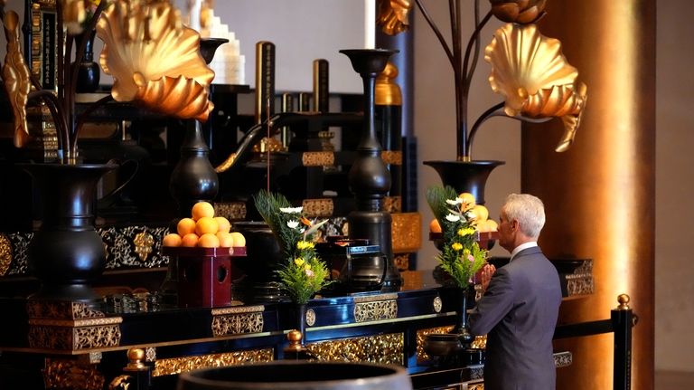 U.S. Ambassador to Japan Rahm Emanuel offers prayers during an...