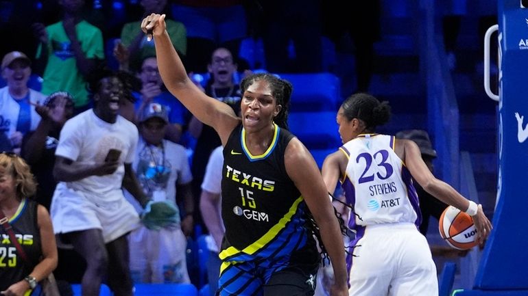 Dallas Wings center Teaira McCowan (15) reacts after scoring the...