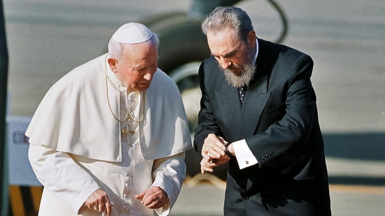 Cuba's President Fidel Castro, and Pope John Paul II, check...