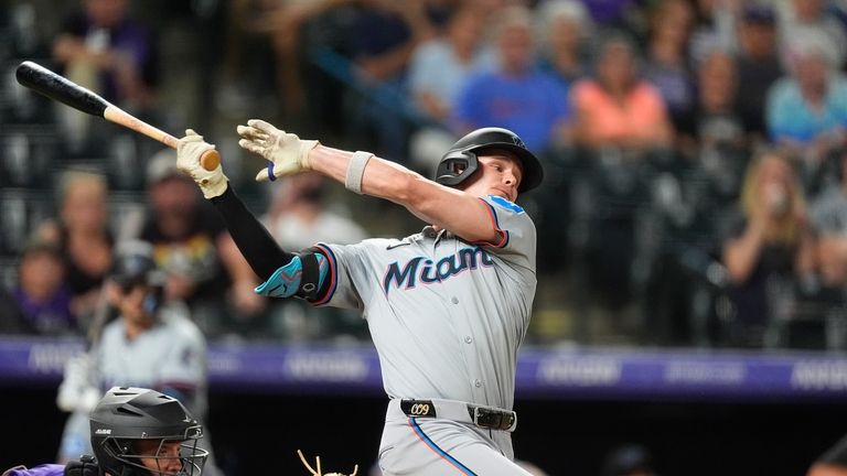 Miami Marlins pinch-hitter Griffin Conine, right, swings at a pitch...