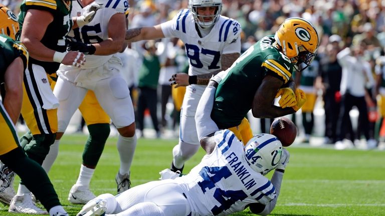 Green Bay Packers running back Josh Jacobs (8) fumbles as...