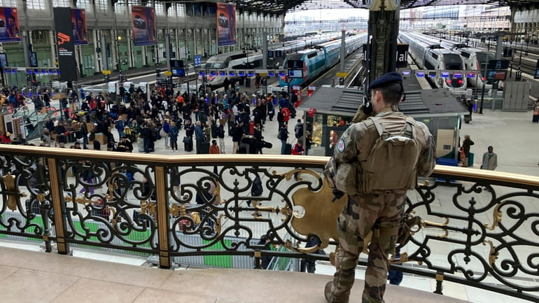 A soldier patrols inside the Gare de Lyon station after...
