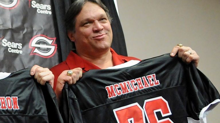 Former Chicago Bears defensive tackle Steve McMichael holds a Chicago...