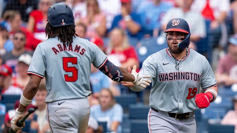 Washington Nationals' Andres Chaparro, right, celebrates his run with C.J....