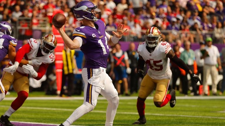 Minnesota Vikings quarterback Sam Darnold (14) throws a 97-yard touchdown...