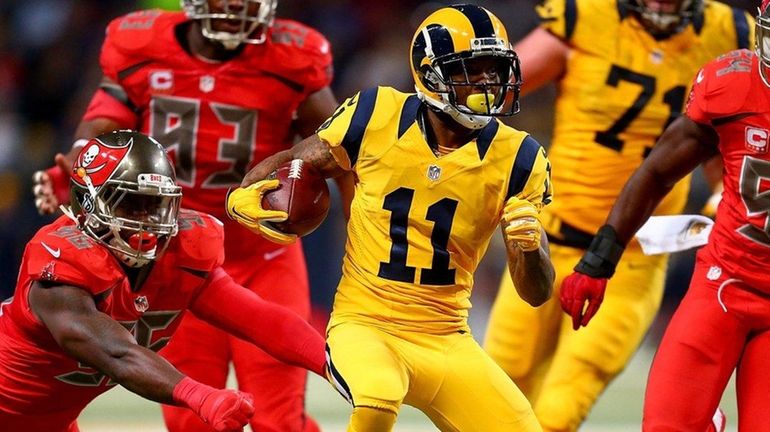 Tavon Austin #11 of the St. Louis Rams rushes in...