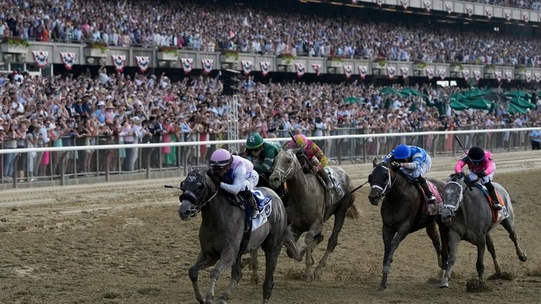 Arcangelo, with jockey Javier Castellano, crosses the finish line to...