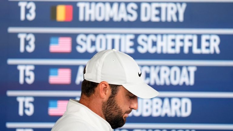 Scottie Scheffler arrives for a news conference at after the...