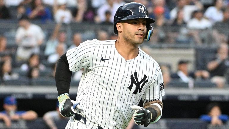 Yankees second baseman Gleyber Torres runs on his solo home...