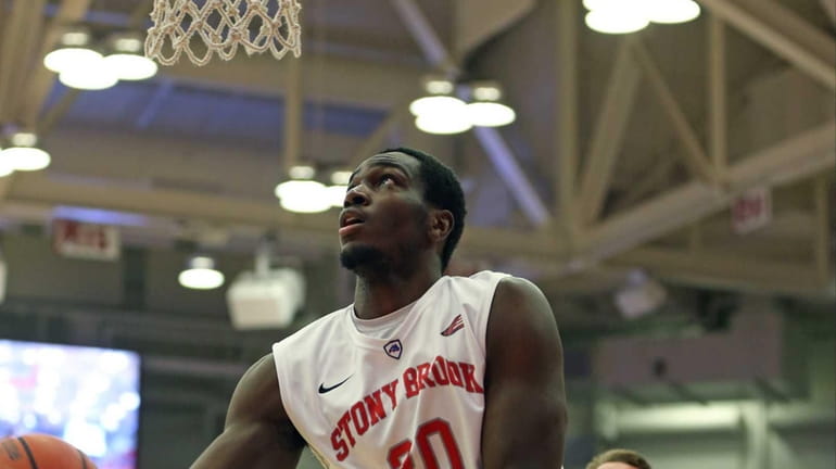 Stony Brook's Jameel Warney #20 goes up for a shot...