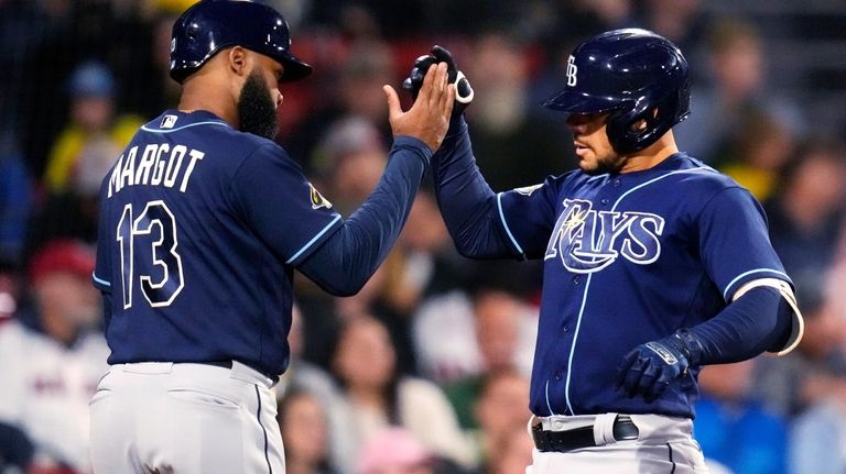 Tampa Bay Rays' Rene Pinto is congratulated by Manuel Margot...